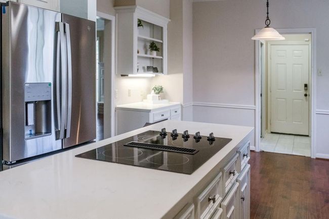 Remodeled kitchen with brand-new refrigerator, quartz countertops. | Image 5