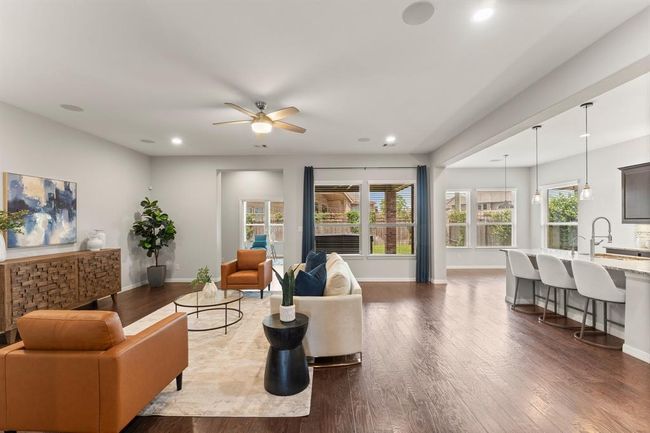 Open-concept living flows seamlessly into the kitchen and dining areas | Image 10