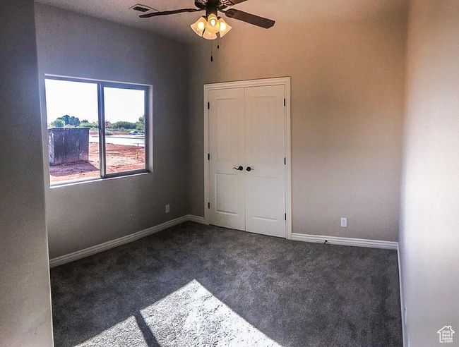Unfurnished bedroom with carpet floors, a closet, baseboards, and visible vents | Image 16