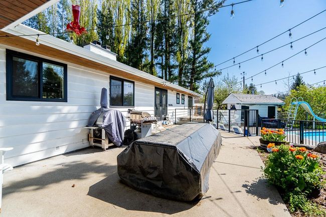 View of patio featuring a fenced in pool | Image 26