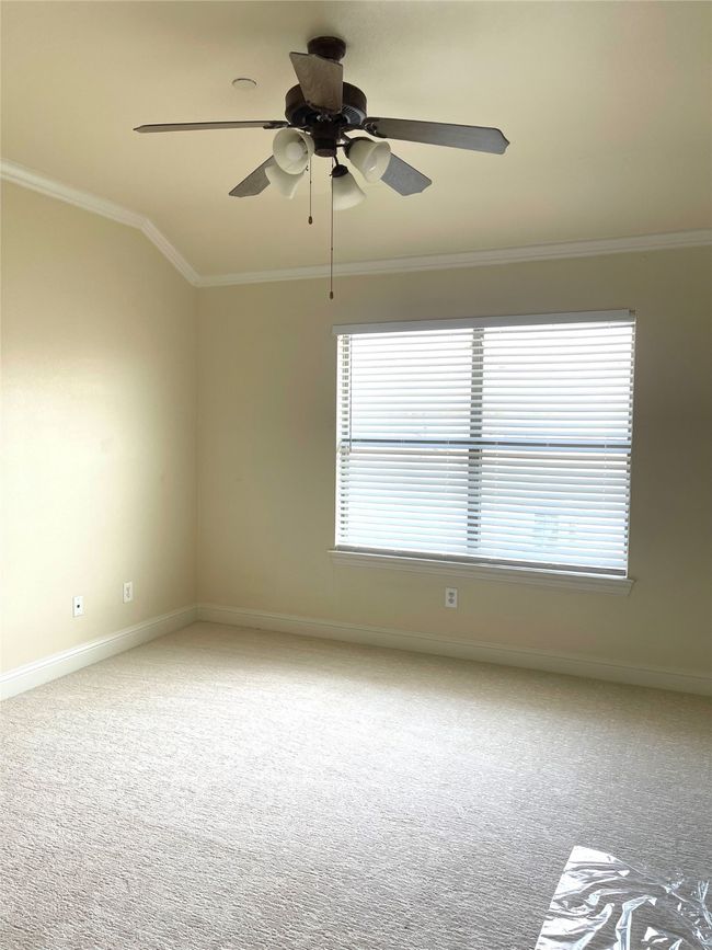 Empty room with ornamental molding, carpet flooring, and ceiling fan | Image 14