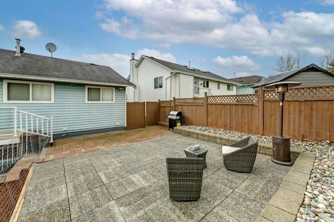 View of patio with a fenced backyard and a grill | Image 34