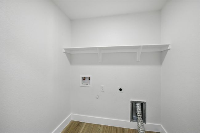 Laundry room with hookup for an electric dryer, dark wood-style flooring, hookup for a gas dryer, hookup for a washing machine, and baseboards | Image 35