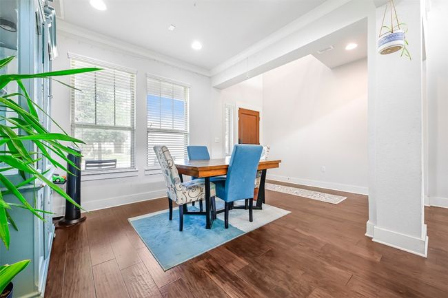 Dining room featuring ornamental molding, dark wood-style flooring, and recessed lighting | Image 5