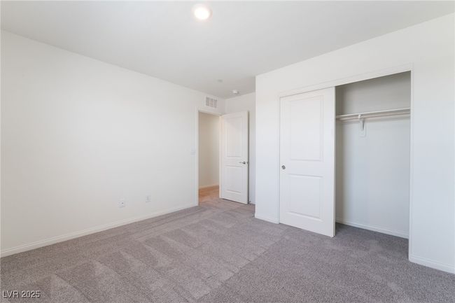 Unfurnished bedroom with carpet floors, a closet, and recessed lighting | Image 25