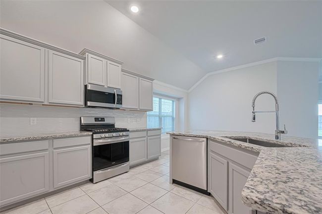 Granite counter tops and modern upgraded cabinetry with crown molding | Image 17