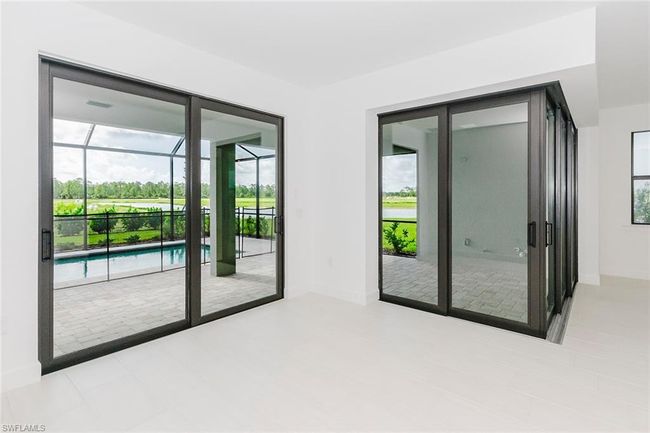 Spare room with a sunroom and baseboards | Image 16