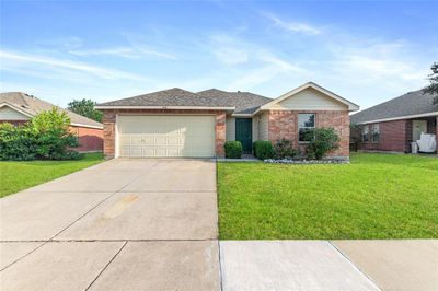 Single story home featuring a garage and a front lawn | Image 1