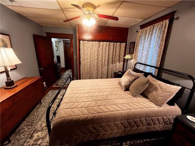 Bedroom featuring a ceiling fan | Image 16