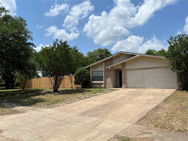 View of front of home featuring brick siding, an attached garage, and concrete driveway | Image 27