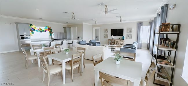 Dining space featuring a ceiling fan, ornamental molding, and baseboards | Image 26