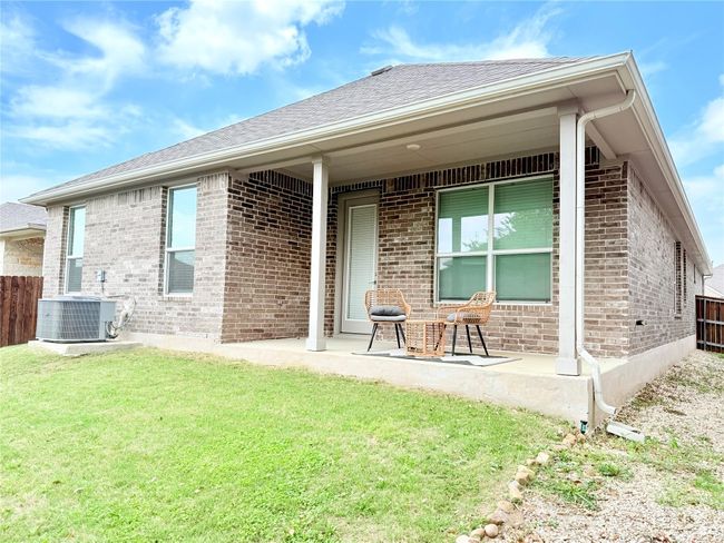 Rear view of property featuring a yard, a patio area, brick siding, and fence | Image 34