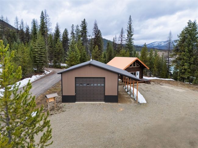 Garage with a mountain view, driveway, and a forest view | Image 49