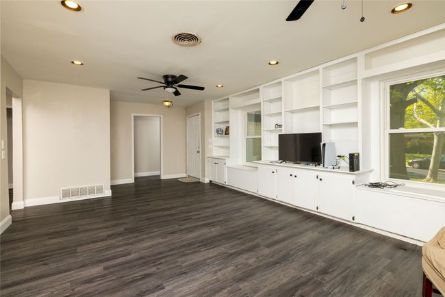 Unfurnished living room featuring visible vents, ceiling fan, recessed lighting, and dark wood-style floors | Image 7
