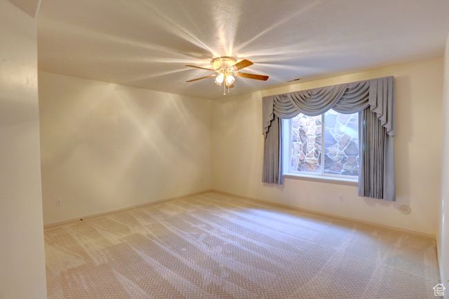 Carpeted spare room with baseboards and a ceiling fan | Image 33