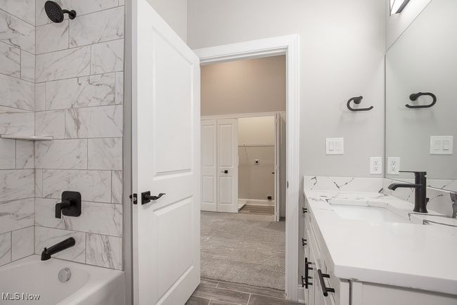 Bathroom with tiled shower / bath combo and vanity | Image 25