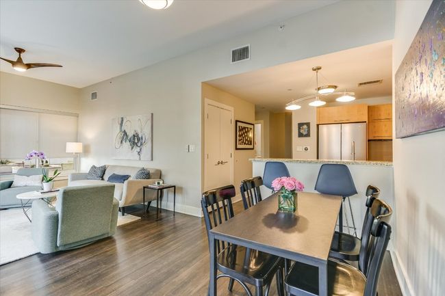 Dining area featuring a ceiling fan, dark wood-type flooring, baseboards, and visible vents | Image 4