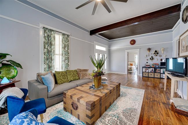 Living area with beam ceiling, hardwood / wood-style flooring, and ceiling fan | Image 8