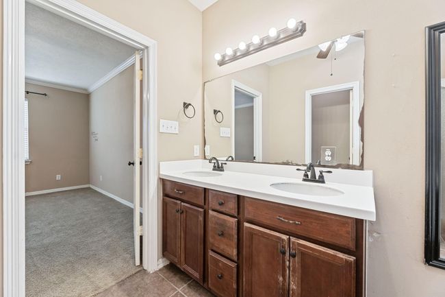 Primary bath includes double vanities, separate tub and shower, and ceiling fan | Image 26