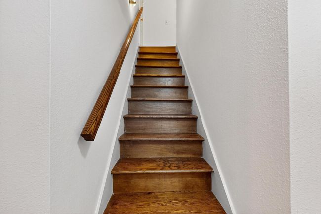 Stairway featuring wood finished floors and a textured wall | Image 12