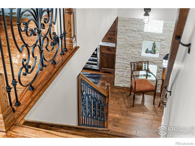 Stairs to Lower Level featuring Cast Iron Railings. Theme of Custom Stonework throughout Home. | Image 25
