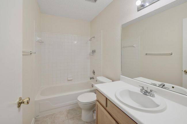 Bathroom featuring vanity, toilet, bathtub / shower combination, and tile patterned floors | Image 21