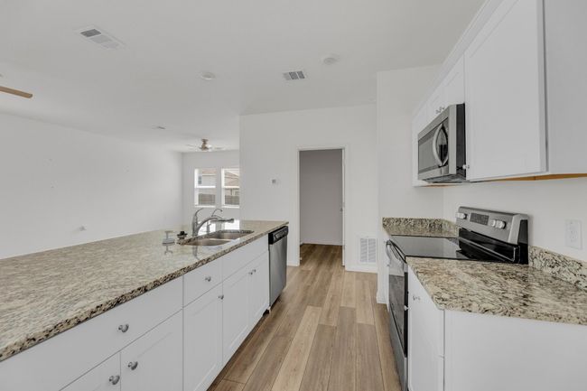 The combination of granite and stainless steel gives this kitchen a contemporary, yet timeless, appeal. | Image 13