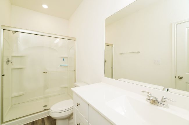 Full bath with a shower stall, vanity, and wood finished floors | Image 14