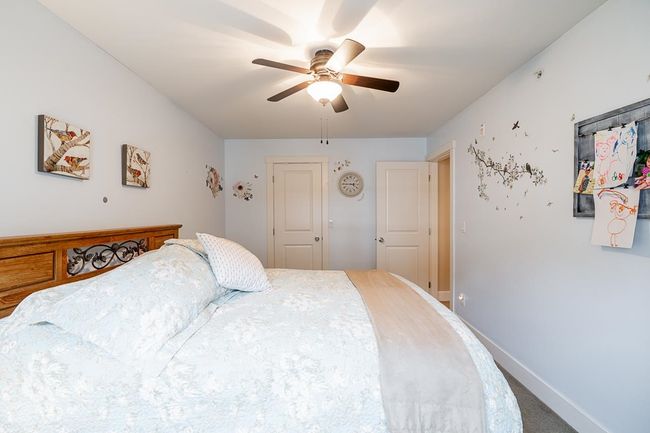 Bedroom with a ceiling fan and baseboards | Image 23
