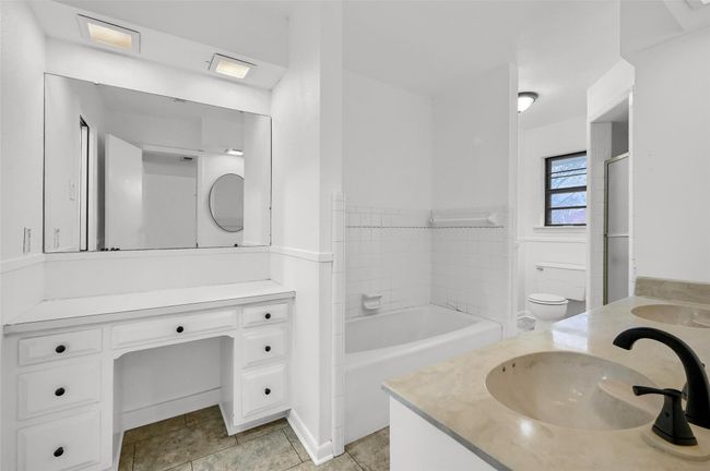 Bathroom with vanity, a tub to relax in, and toilet | Image 25
