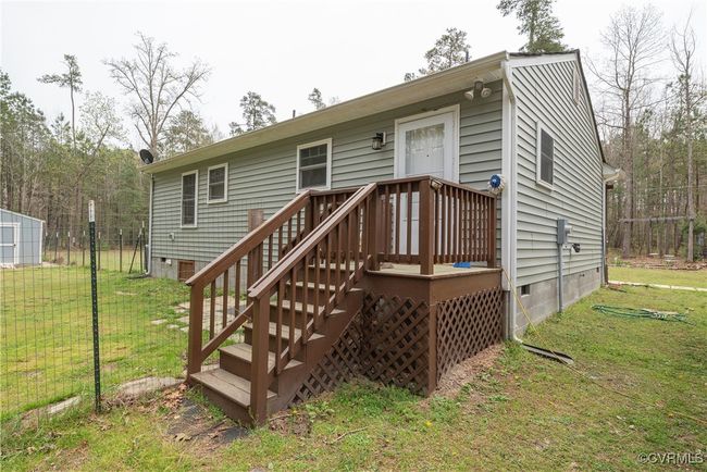 Rear view of property with crawl space and a lawn | Image 35