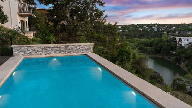 Pool at dusk with an outdoor pool and a water view | Image 32