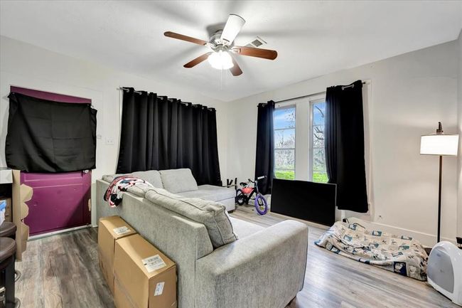 Bright living room with multiple windows and vinyl floors. | Image 39