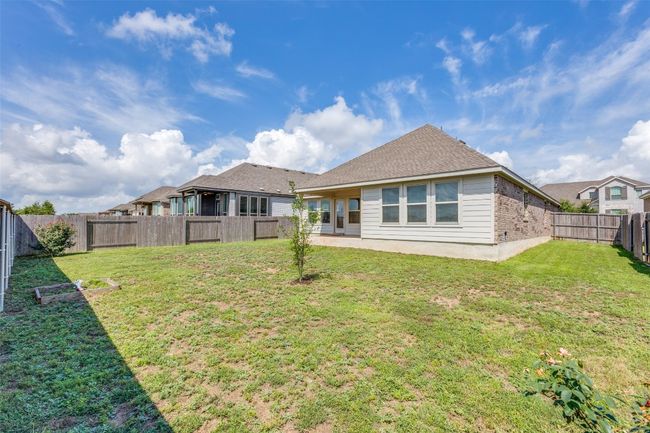 Back of property with roof with shingles and a fenced backyard | Image 24