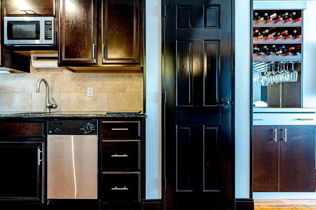 Kitchen includes Microwave, dishwasher, under counter fridge and beautiful custom wine rack. | Image 7