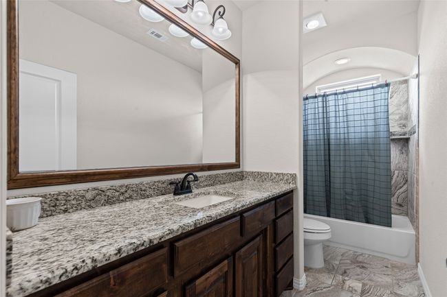 Bathroom featuring toilet, vanity, mfinish floors, and shower / tub combination | Image 10