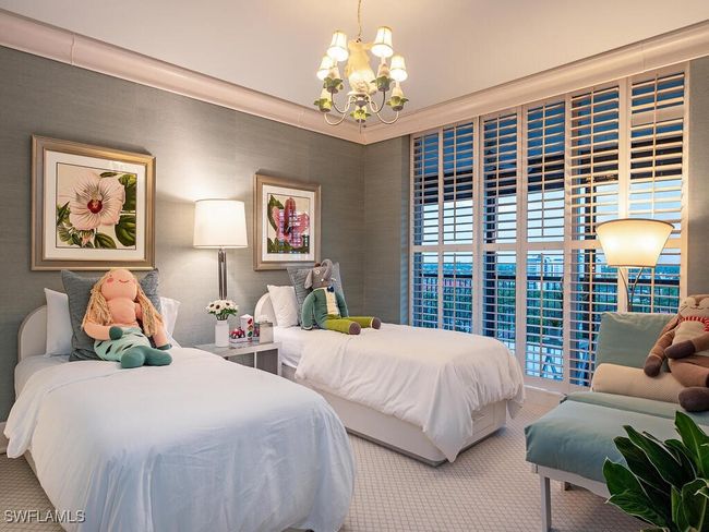 Bedroom 2 featuring a chandelier, custom wood blinds and carpet flooring | Image 19