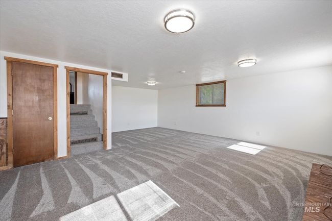 Spare room featuring carpet flooring and stairs | Image 28