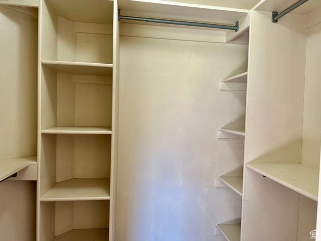 View of walk in closet in primary bedroom with great storage and organization | Image 9