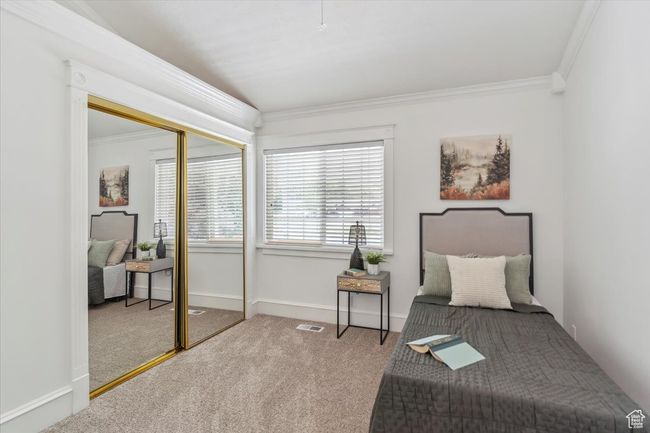 Bedroom featuring carpet flooring, ornamental molding, a closet, and baseboards | Image 24