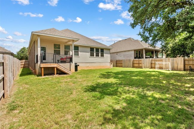 Rear view of house with a fenced backyard and a shingled roof | Image 32