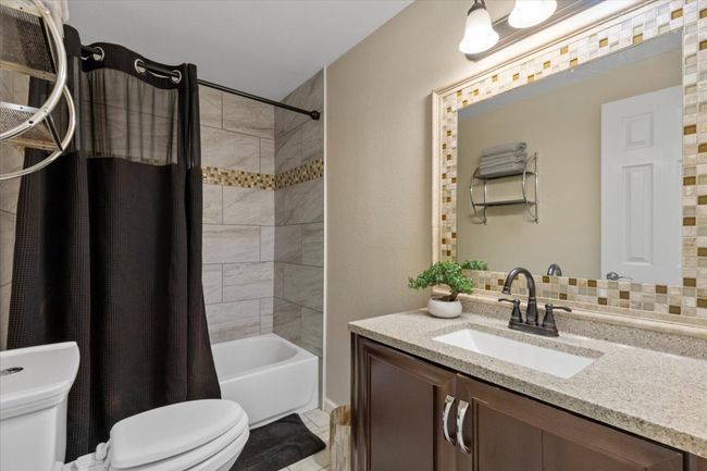 Full bath with toilet, shower / bath combo, and vanity | Image 20