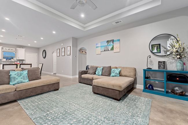 Living room with a tray ceiling and ceiling fan | Image 7