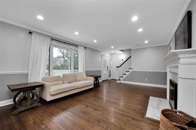 Living area featuring recessed lighting, hardwood / wood-style floors, ornamental molding, baseboards, and stairs | Image 5