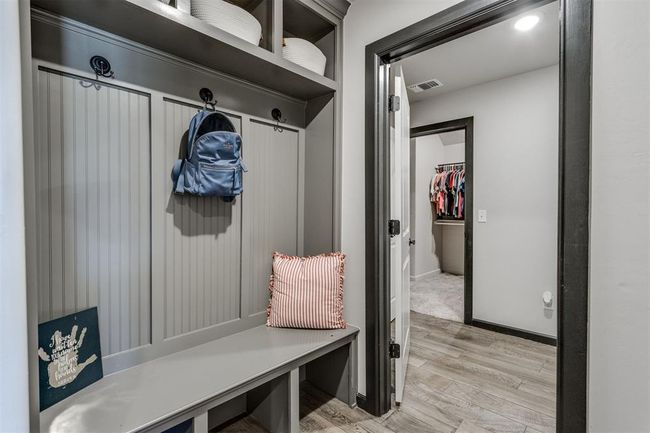 Mudroom with light wood-type flooring, baseboards, and visible vents | Image 9