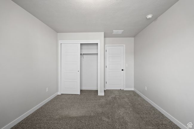 Unfurnished bedroom with carpet flooring and a closet | Image 35