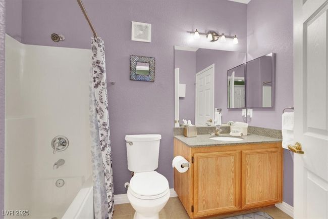 Bathroom featuring shower / bath combo, vanity, toilet, visible vents, and baseboards | Image 29