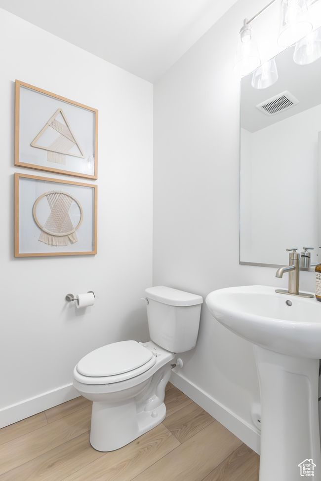 Bathroom with toilet and wood finished floors | Image 32