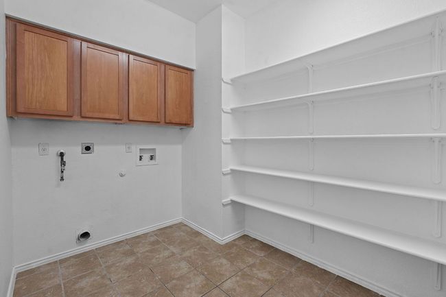 Washroom featuring hookup for a gas dryer, hookup for an electric dryer, baseboards, and washer hookup | Image 28