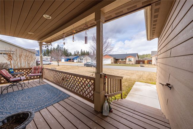 Wooden deck featuring a residential view and covered porch | Image 30
